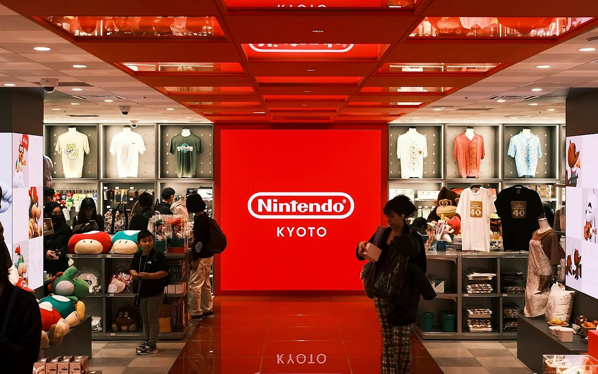 Loja de games associada à compra de GTA 6 no Xbox Corredor de loja de games com vitrines iluminadas e clientes circulando entre as prateleiras