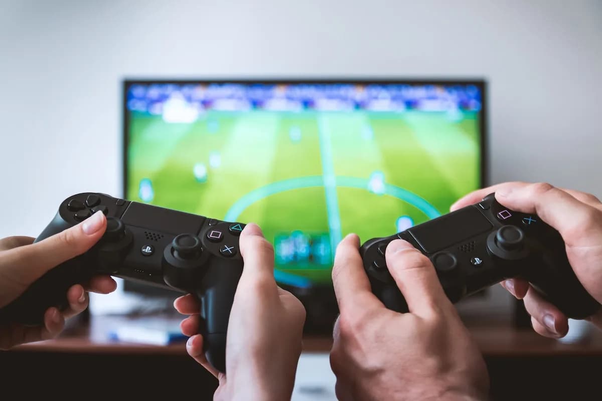 TV 60Hz ou 120Hz para Games — Qual Escolher em 2026 TV exibindo jogo de ação em alta fluidez com consoles PS5 e Xbox Series X conectados via HDMI 2.1