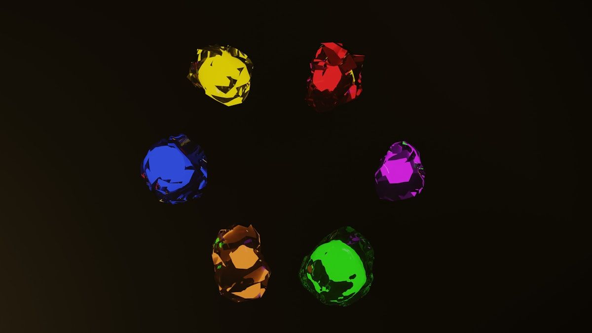 Um conjunto de pedras coloridas sobre um fundo preto, simbolizando diversidade e criatividade