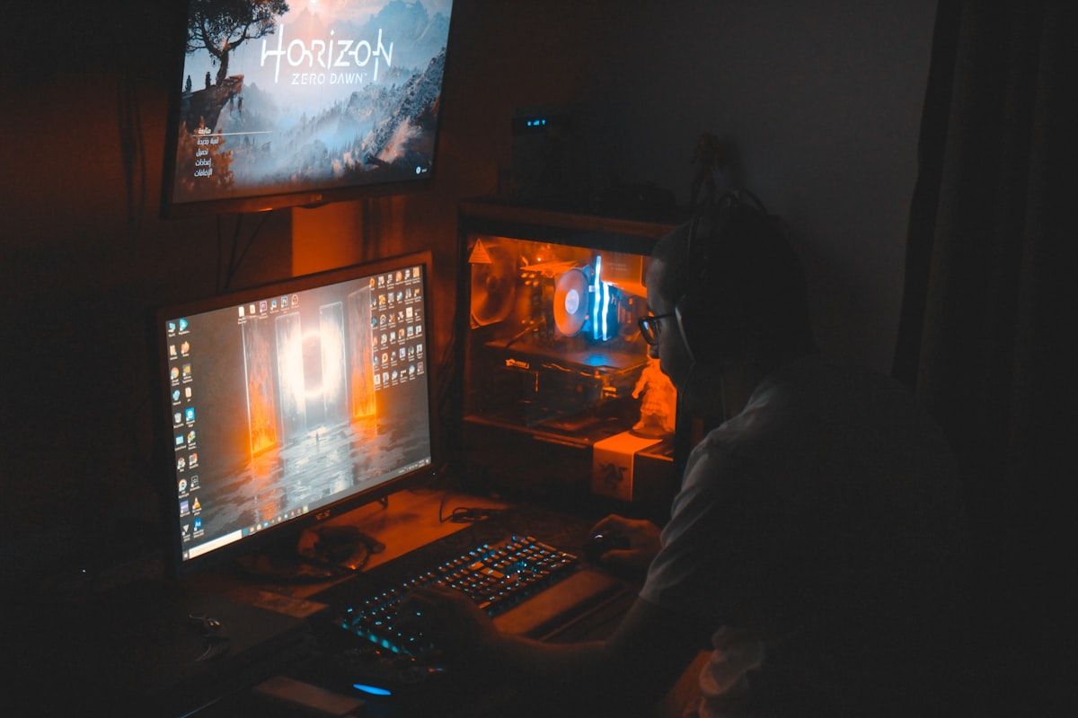 Monitor PC Gamer Preto com Teclado Preto em Uso Monitor de computador gamer preto ligado ao lado de um teclado preto, ideal para jogos